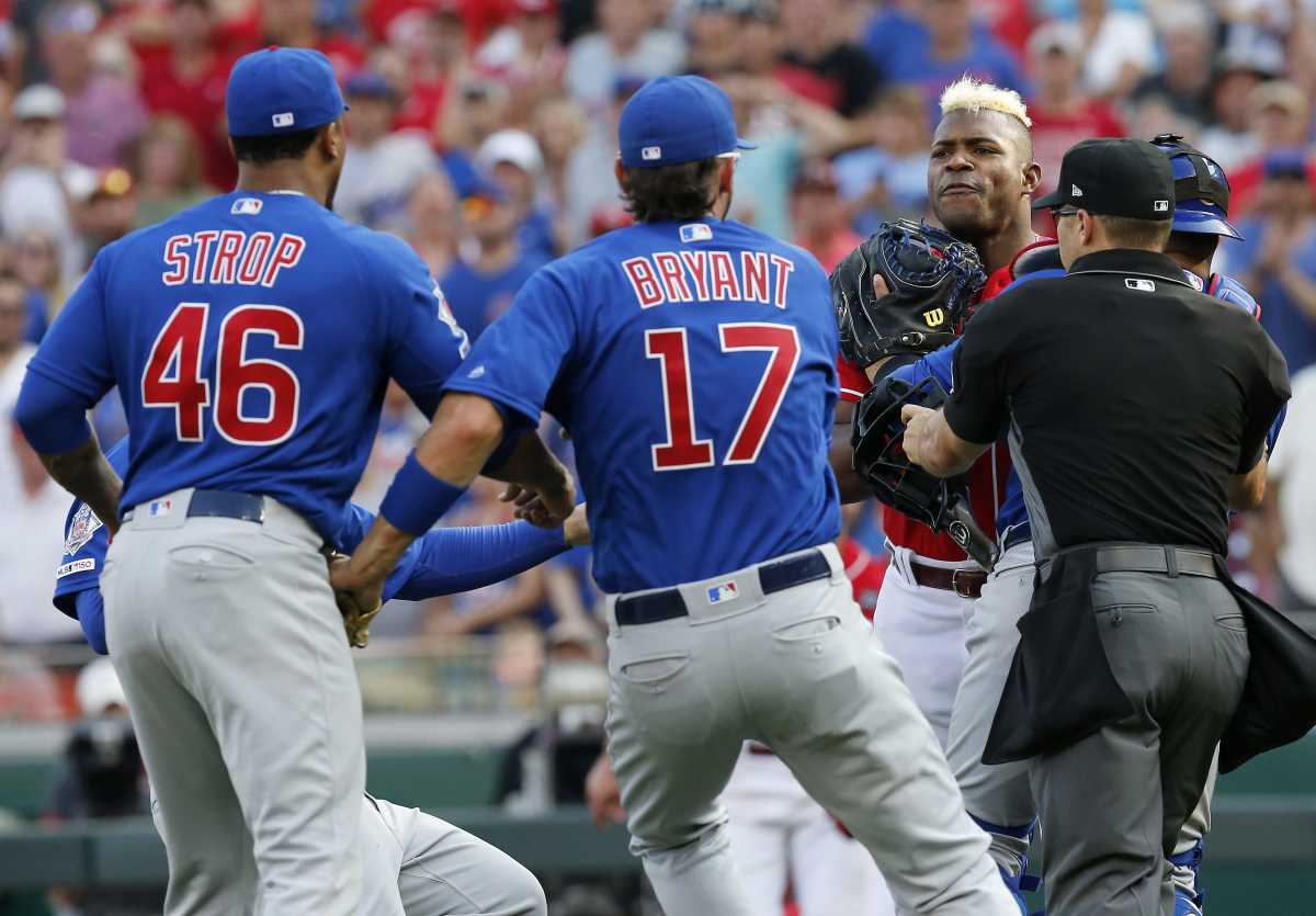 Cincinnati Reds right fielder Yasiel Puig (66) charges the mound after being hit by Chicago Cubs relief pitcher Pedro Strop (46) in the eighth inning at Great American Ball Park on Saturday, June 29, 2019. Chicago Cubs At Cincinnati Reds  